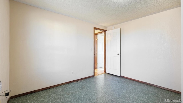 spare room with a textured ceiling