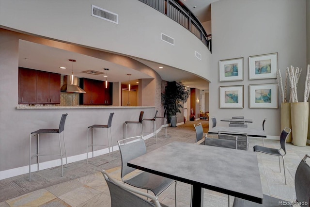 dining space with a towering ceiling