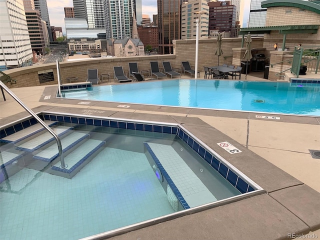 view of pool featuring area for grilling