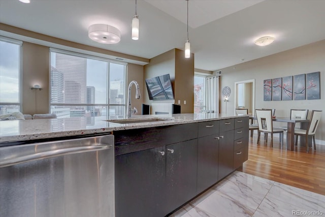 kitchen with dishwasher, sink, and decorative light fixtures