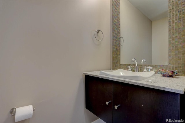 bathroom with vanity and tasteful backsplash