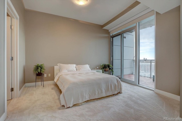 carpeted bedroom with access to exterior and a water view