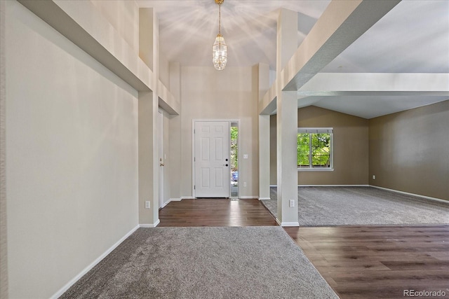 5932 S Versailles St, Aurora, CO 80015 - carpeted entryway featuring wood finished floors and vaulted ceiling