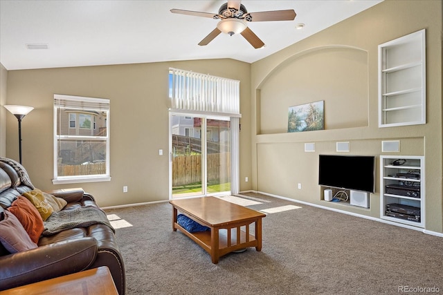 5932 S Versailles St, Aurora, CO 80015 - carpeted living area featuring healthy amount of natural light, lofted ceiling, built in shelves, and a ceiling fan