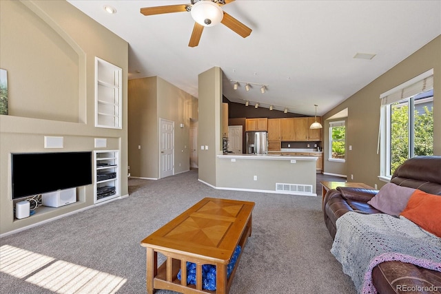 5932 S Versailles St, Aurora, CO 80015 - living area with vaulted ceiling, a ceiling fan, dark carpet, and built in shelves
