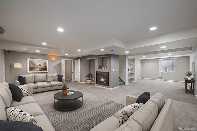 5932 S Versailles St, Aurora, CO 80015 - living room with light colored carpet, recessed lighting, and a warm lit fireplace