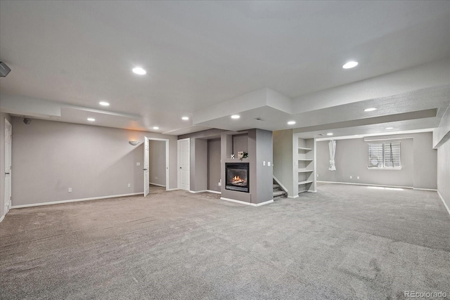 5932 S Versailles St, Aurora, CO 80015 - basement featuring recessed lighting, a glass covered fireplace, carpet floors, stairs, and built in features