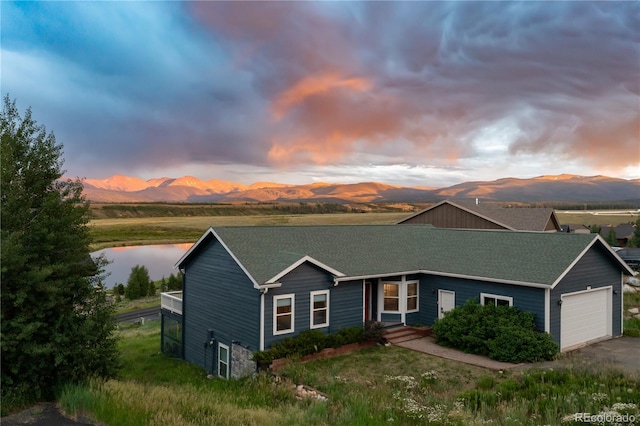 1624 Gcr 5221, Tabernash, CO 80478 - view of front of house with a garage, roof with shingles, a water and mountain view, and driveway