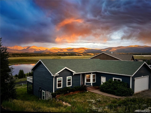 1624 Gcr 5221, Tabernash, CO 80478 - view of front of property featuring roof with shingles, an attached garage, and a water and mountain view