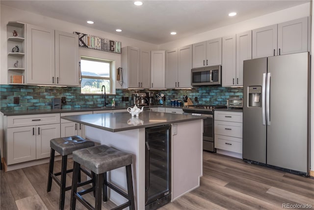 1624 Gcr 5221, Tabernash, CO 80478 - kitchen with stainless steel appliances, dark countertops, beverage cooler, open shelves, and a breakfast bar