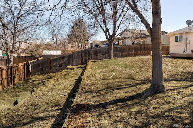 view of yard featuring a fenced backyard and a residential view