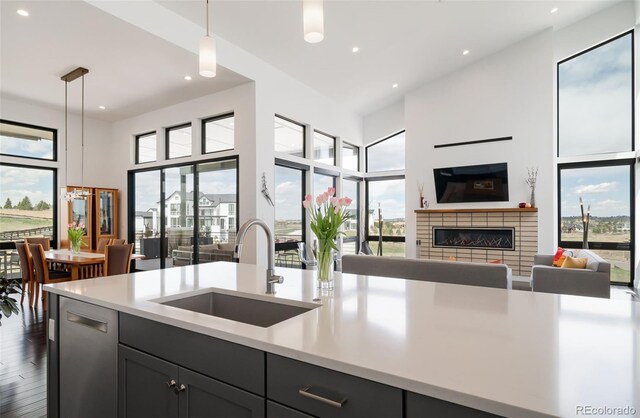 8765 Canyon Wind St, Parker, CO 80138 - kitchen featuring open floor plan, light countertops, recessed lighting, a high ceiling, and decorative light fixtures