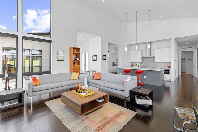 8765 Canyon Wind St, Parker, CO 80138 - living area featuring a towering ceiling and dark wood-type flooring