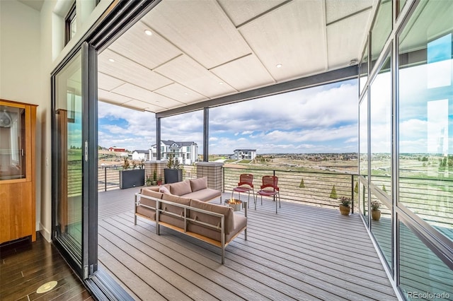 8765 Canyon Wind St, Parker, CO 80138 - sunroom / solarium with a wall of windows, hardwood / wood-style floors, and outdoor lounge area