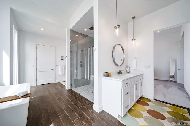 8765 Canyon Wind St, Parker, CO 80138 - full bathroom featuring vanity, a stall shower, wood finished floors, and recessed lighting