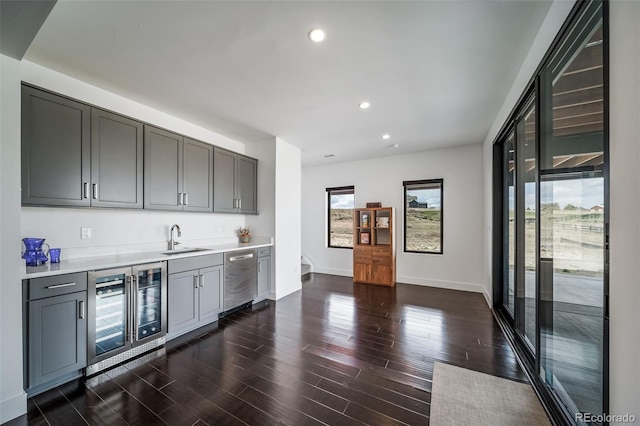 8765 Canyon Wind St, Parker, CO 80138 - indoor wet bar with beverage cooler, stainless steel dishwasher, dark wood-style flooring, and recessed lighting