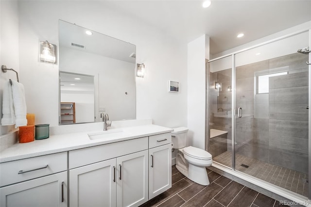 8765 Canyon Wind St, Parker, CO 80138 - full bath with vanity, a stall shower, recessed lighting, and wood tiled floors