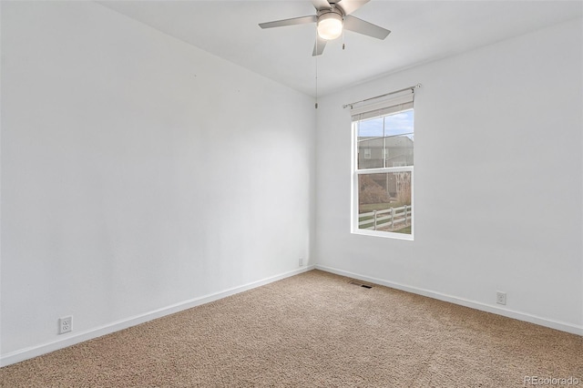 carpeted spare room featuring ceiling fan