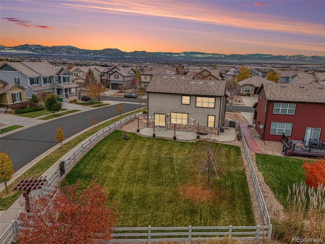 aerial view at dusk featuring a mountain view