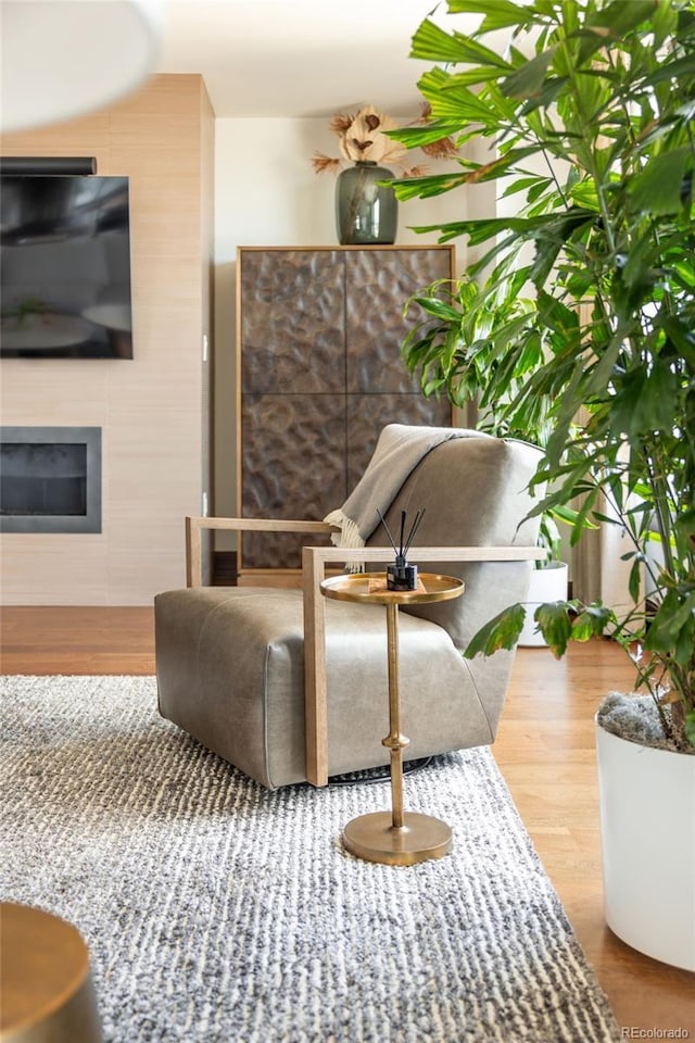 1133 14th St Unit 2000, Denver, CO 80202 - living area featuring a glass covered fireplace and wood finished floors