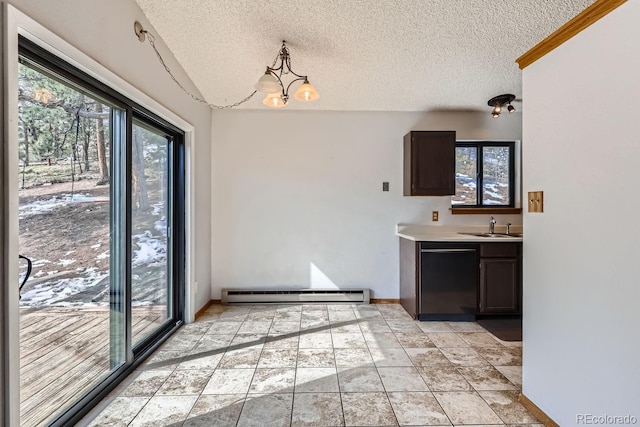 kitchen with a sink, a baseboard heating unit, dishwasher, and a healthy amount of sunlight