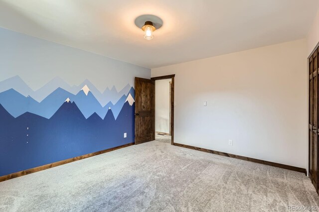 empty room with carpet flooring and baseboards