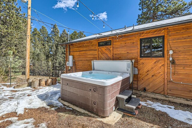 exterior space with fence and a hot tub