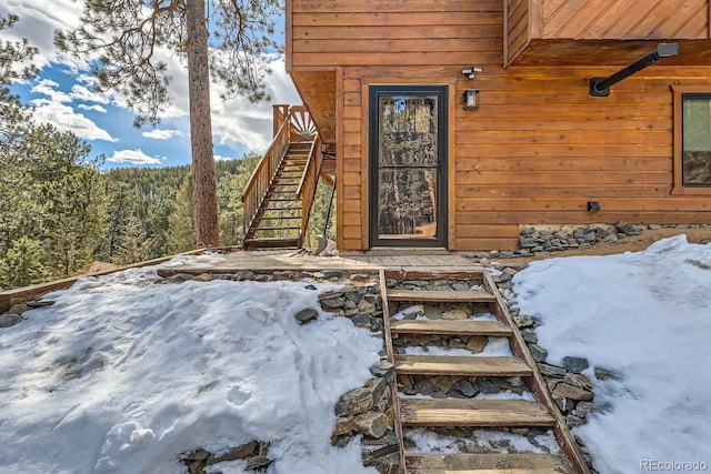 view of snow covered property entrance