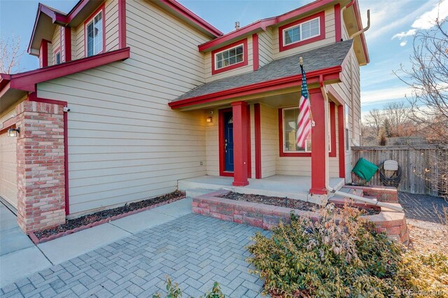 view of front of property with a porch and a garage