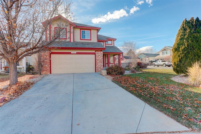 view of property with a front yard and a garage