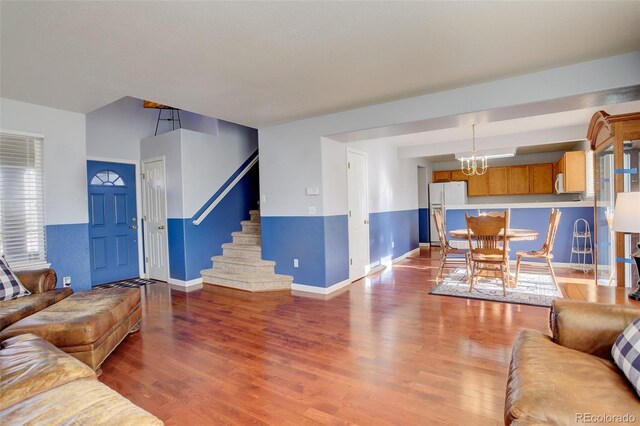 living room with hardwood / wood-style floors and a chandelier