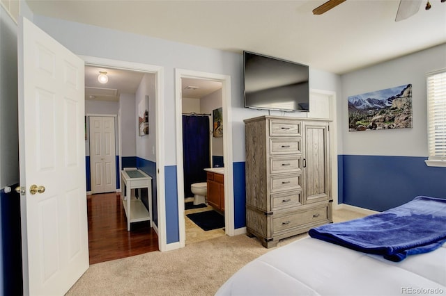 carpeted bedroom featuring ceiling fan, a spacious closet, and connected bathroom