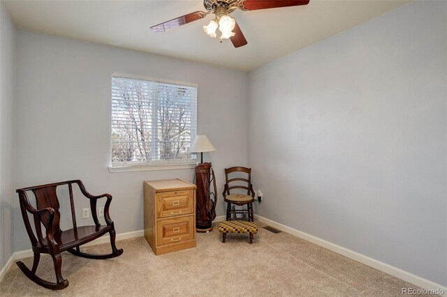 sitting room featuring ceiling fan and light colored carpet