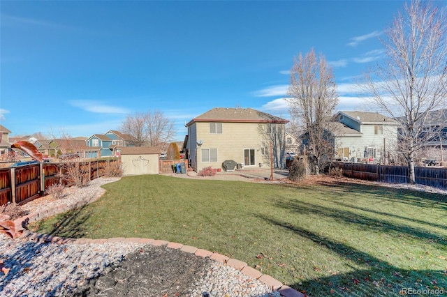 back of house with a lawn and a storage unit