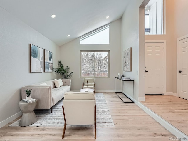 living room featuring light hardwood / wood-style floors and high vaulted ceiling