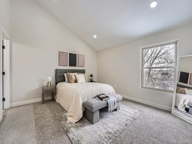 bedroom with carpet flooring and high vaulted ceiling