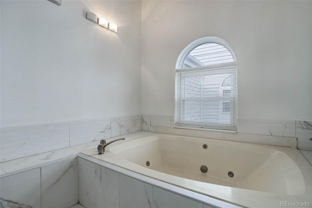 bathroom with tiled tub