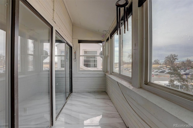 unfurnished sunroom with vaulted ceiling