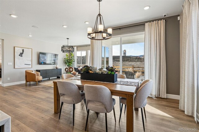 17136 W 92nd Loop, Arvada, CO 80007 - dining room with an inviting chandelier, recessed lighting, baseboards, and wood finished floors
