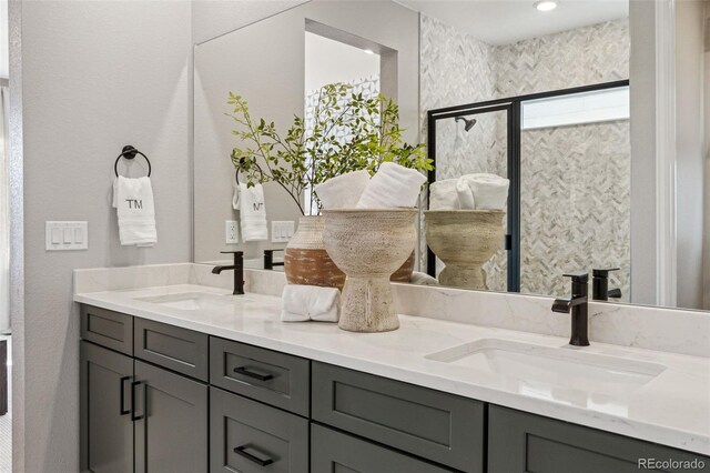 full bathroom with double vanity and a sink