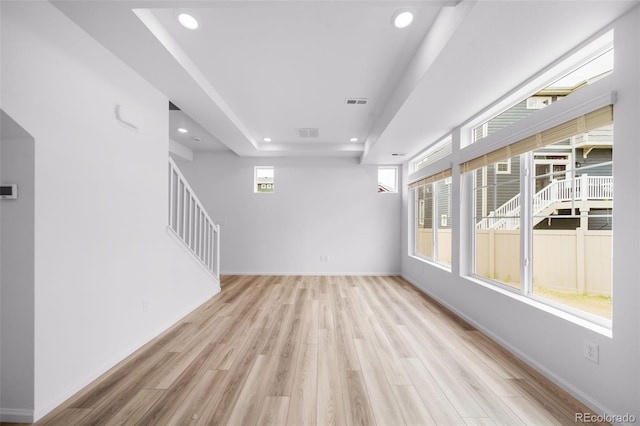 1175 Highview Dr, Erie, CO 80516 - spare room with a tray ceiling, light wood finished floors, recessed lighting, stairs, and baseboards