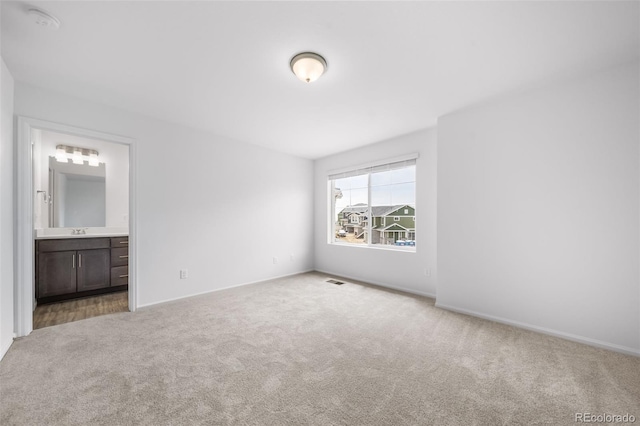 1175 Highview Dr, Erie, CO 80516 - unfurnished bedroom with carpet flooring, a sink, baseboards, and connected bathroom