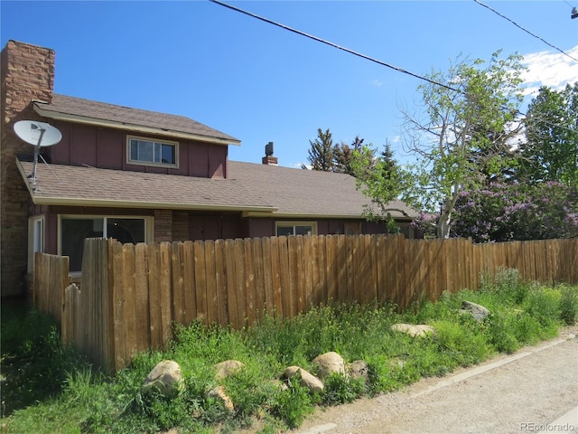 135 E 2nd St, Nederland, CO 80466 - view of home's exterior with board and batten siding and a chimney