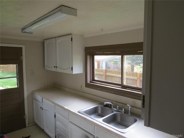 135 E 2nd St, Nederland, CO 80466 - kitchen featuring plenty of natural light, white cabinets, and ornamental molding
