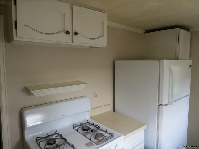 135 E 2nd St, Nederland, CO 80466 - kitchen with white appliances, light countertops, white cabinets, and crown molding