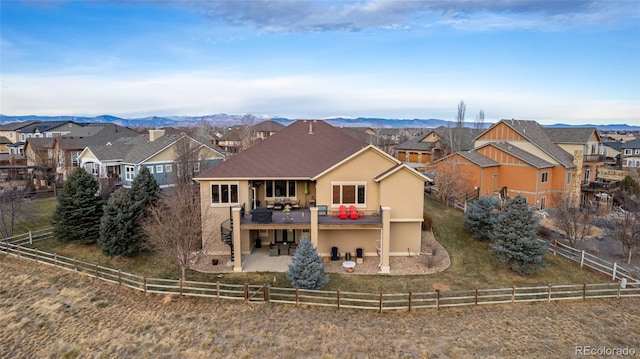 rear view of house featuring a deck with mountain view and a patio area