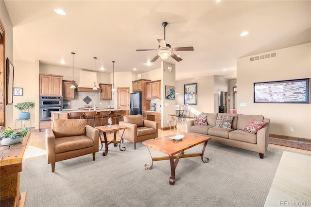 living room with ceiling fan and sink