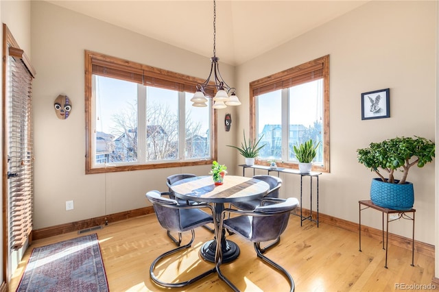 dining area featuring a chandelier and light hardwood / wood-style floors