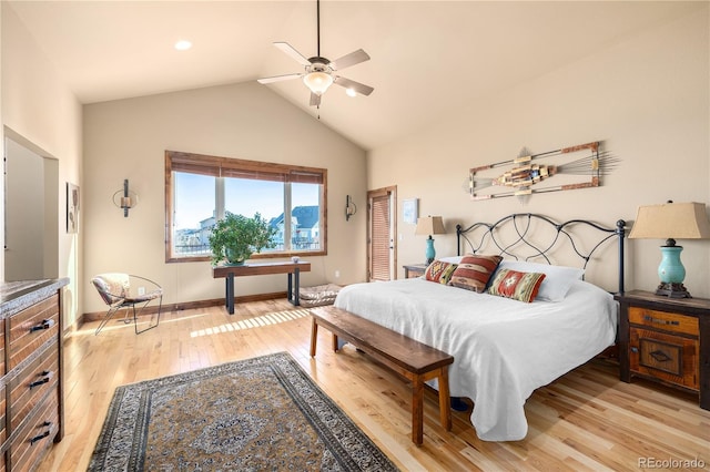 bedroom with ceiling fan, light hardwood / wood-style flooring, and vaulted ceiling