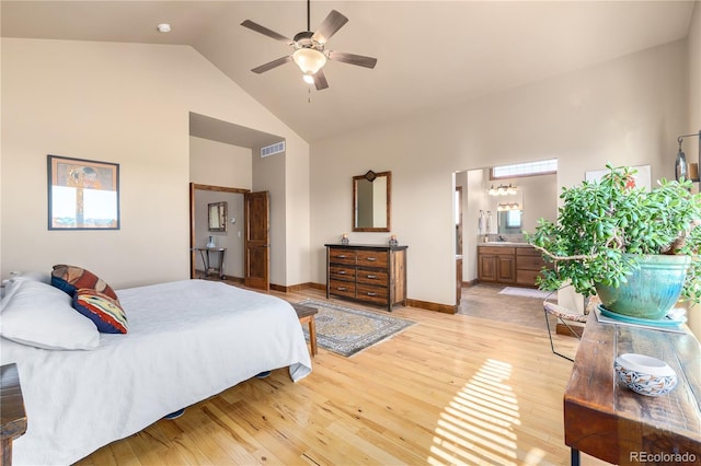 bedroom featuring high vaulted ceiling, ceiling fan, light wood-type flooring, and connected bathroom